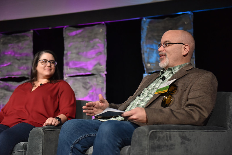 OLC Fellows sit together on stage, delivering a plenary panel at OLC Accelerate 2024