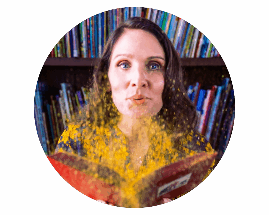 Headshot of Dr. Lisa Hassler. She holds an open book and blows gold glitter out of it towards the camera.